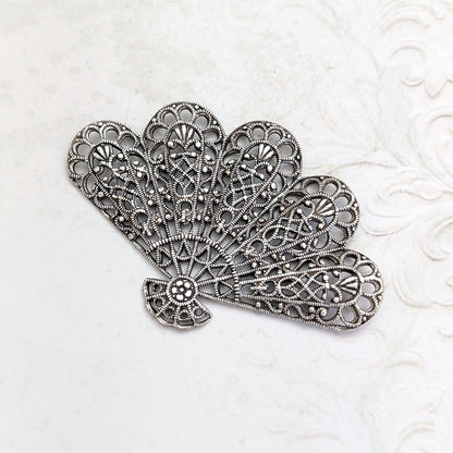An antiqued silver-plated brass fan-shaped filigree for jewelry making or crafts